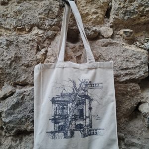 The Champollion's tree tattoo tote bag on stone at the palace.